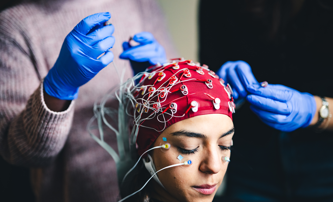 A research assistant wears an EEG cap in the Patrick Cox lab.